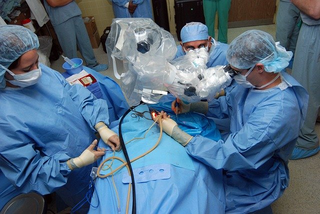 Surgeons working, sterile field, advanced equipment
