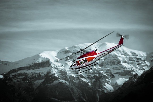 Helicopter flying by mountains