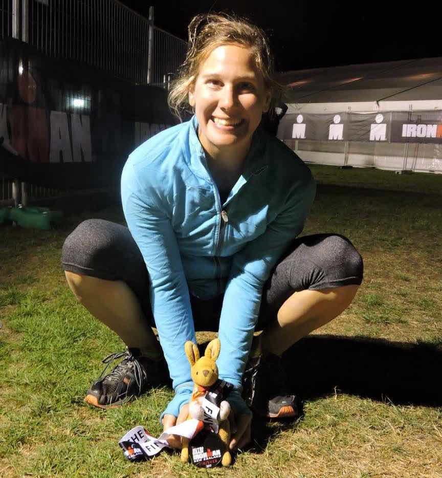 Dr. Ann Herbst with a stuffed kangaroo and an Ironman Finisher Medal