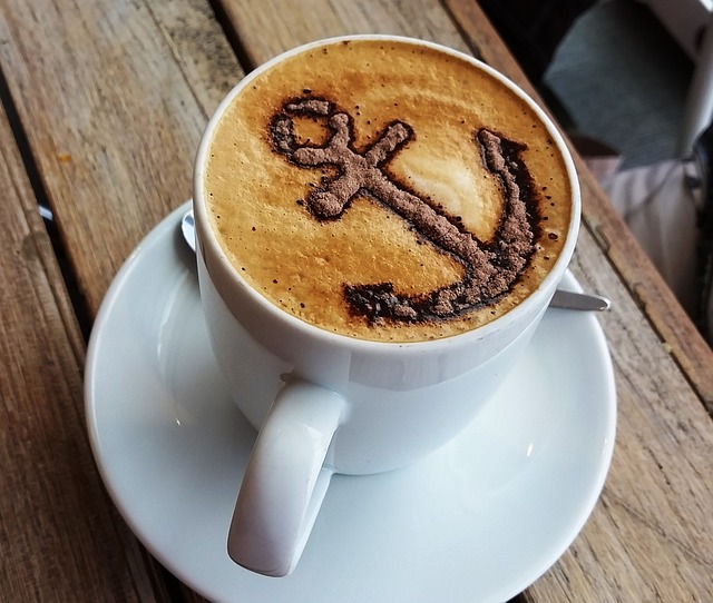 coffee cup with an anchor art with chocolate powder