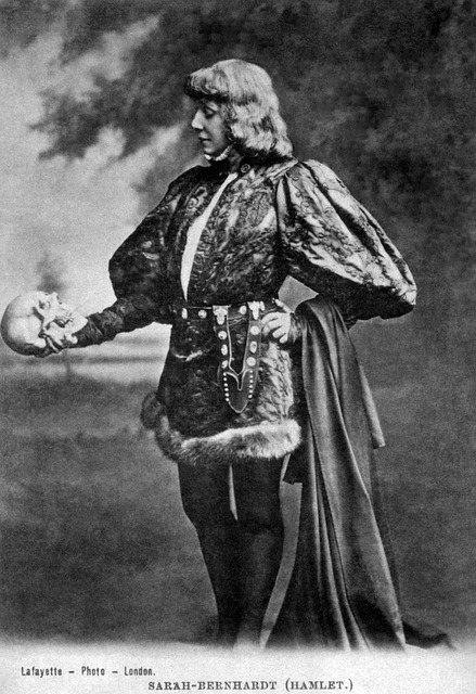 Image of old play, Hamlet holding the skull. 