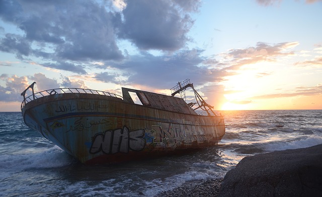 Ship half sunk on it's side, abandoned.