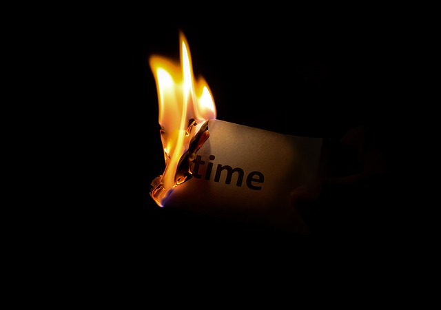 Piece of paper that says 'time' on fire