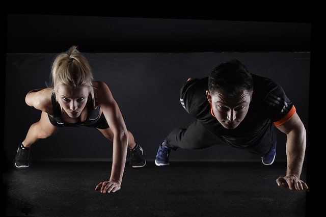 Two people doing one-armed push-ups