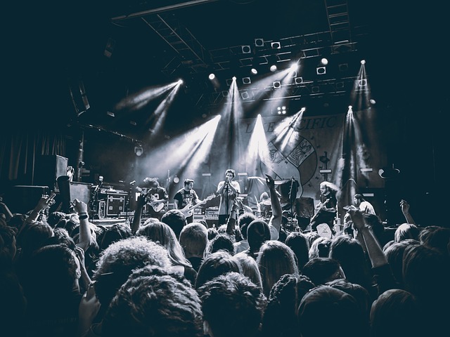 black and white photo of a band on a stage.