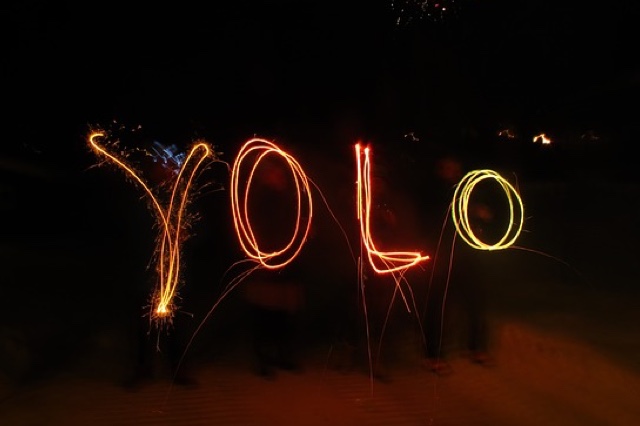 YOLO written with sparklers in the dark