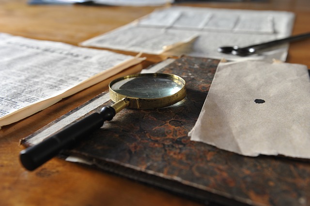 Magnifying glass on old papers and ink blots. 