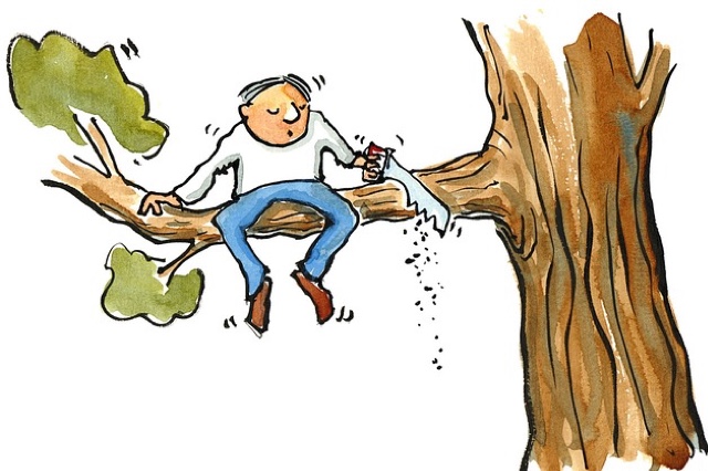 Man sitting in a tree, sawing off the limb of the tree he is sitting on, such that he will fall