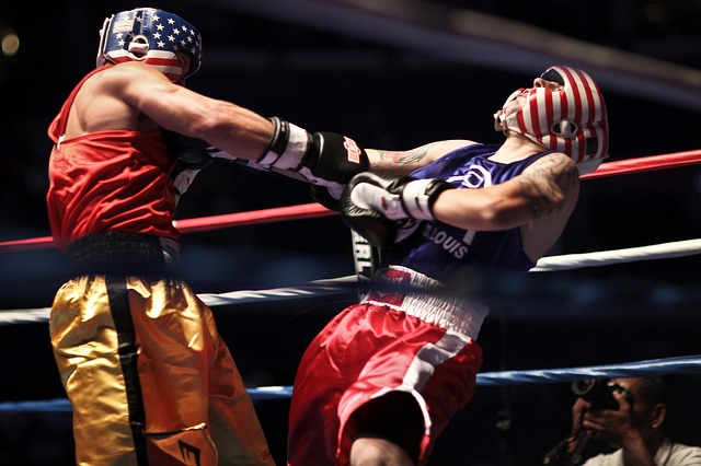 Two boxers, one punching the other out.