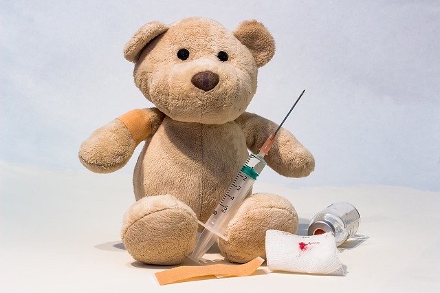 Teddy bear with vaccine needle